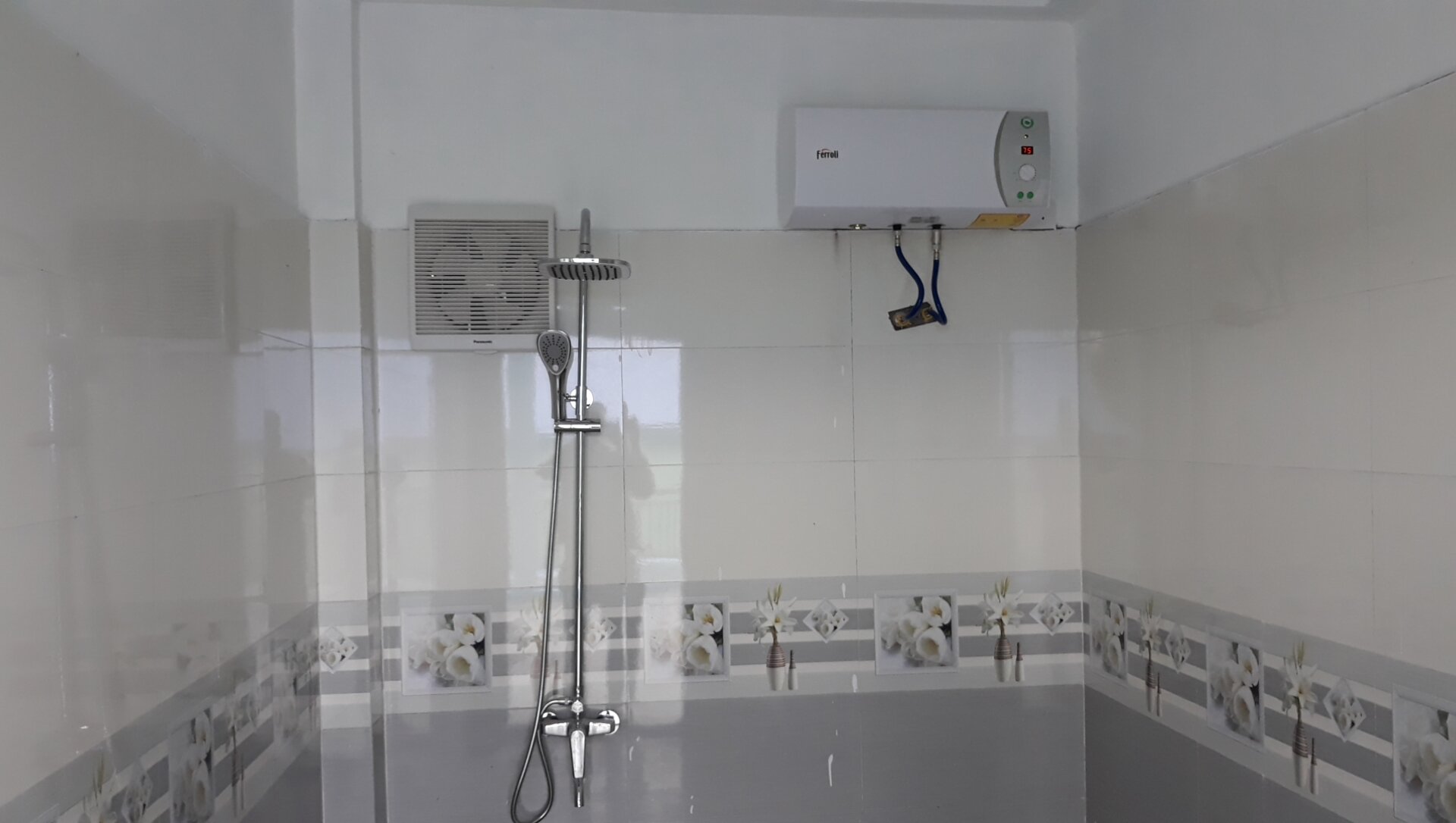 Kỹ thuật viên kiểm tra áp lực nước khi lắp máy nước nóng có bơm trợ lực